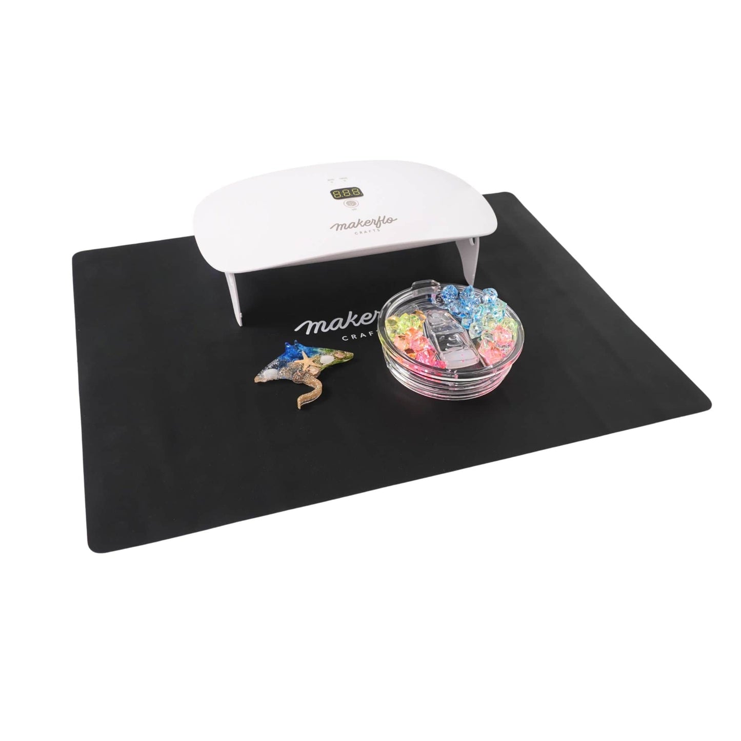 uv resin lamp on mat with crafted tumbler topper and animal