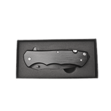 closed black metal pocket knife in black foam gift box