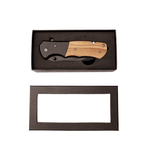 Folding knife with wooden handle in a black presentation box on a white background