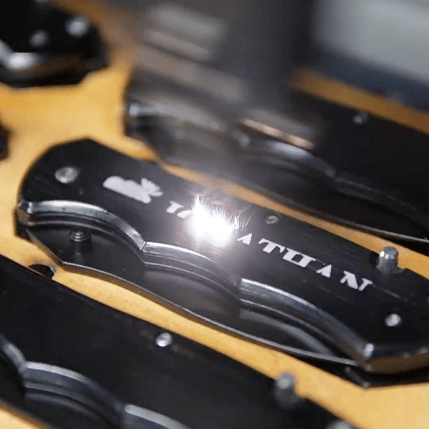 Bulk pocket knives for laser engraving - being engraved