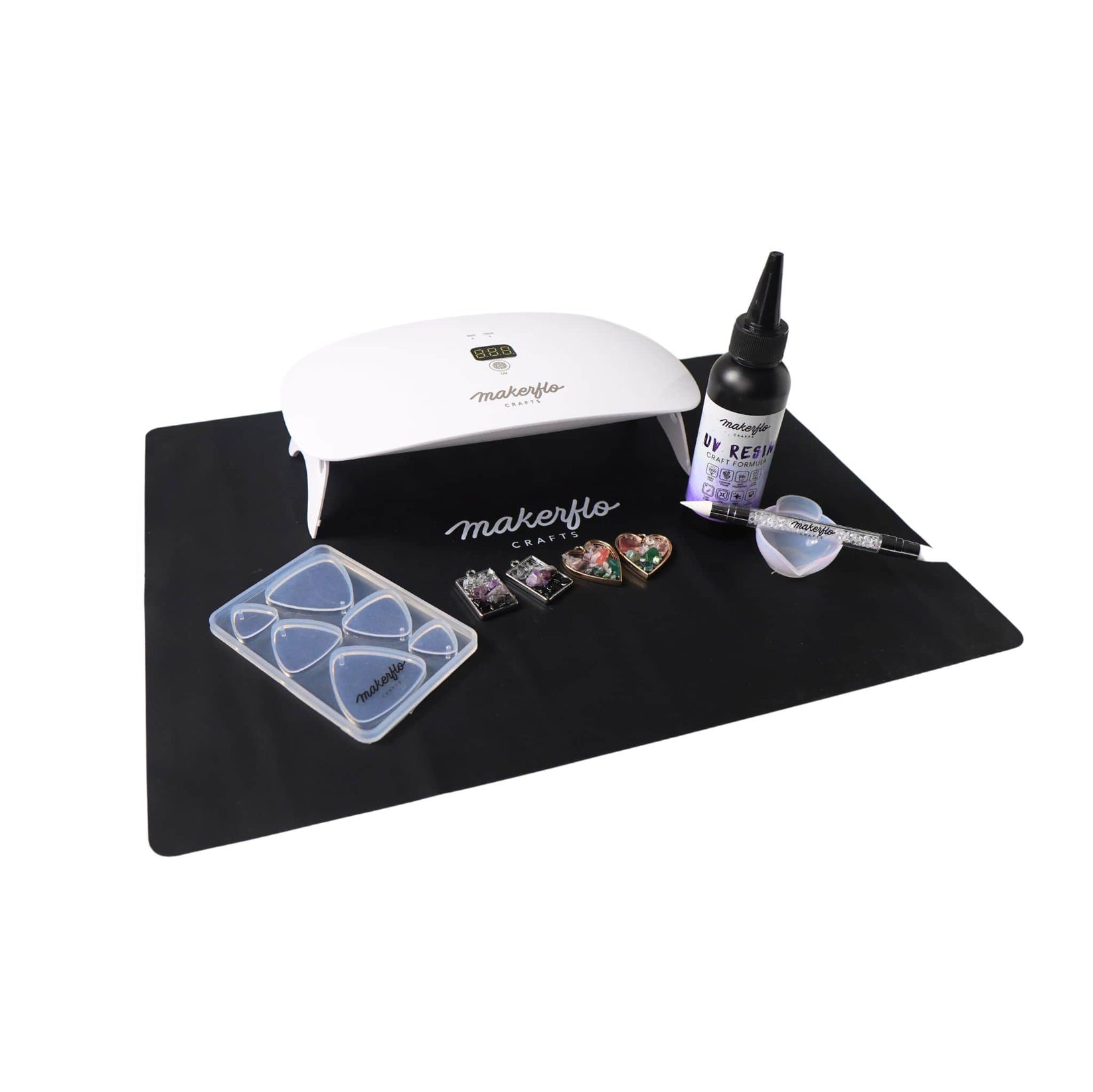 uv resin lamp & LED light, mat with uv resin, mixing bowl, wand and crafted jewelry pendants